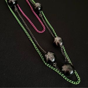 Colorful multi strand chain necklace, black marbles, flower pattern.